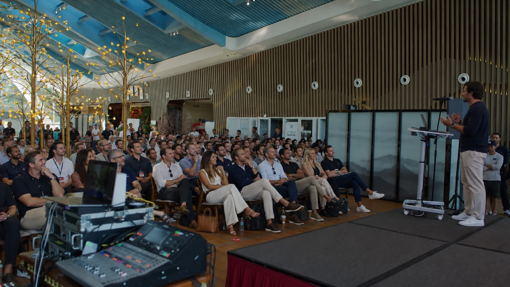 People gathered for a live presentation in a bright CRAYS gathering space