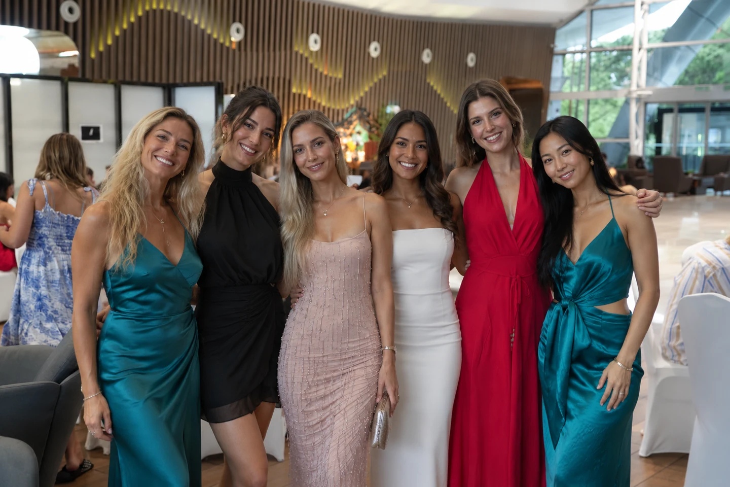 Friends wearing colourful occasion outfits