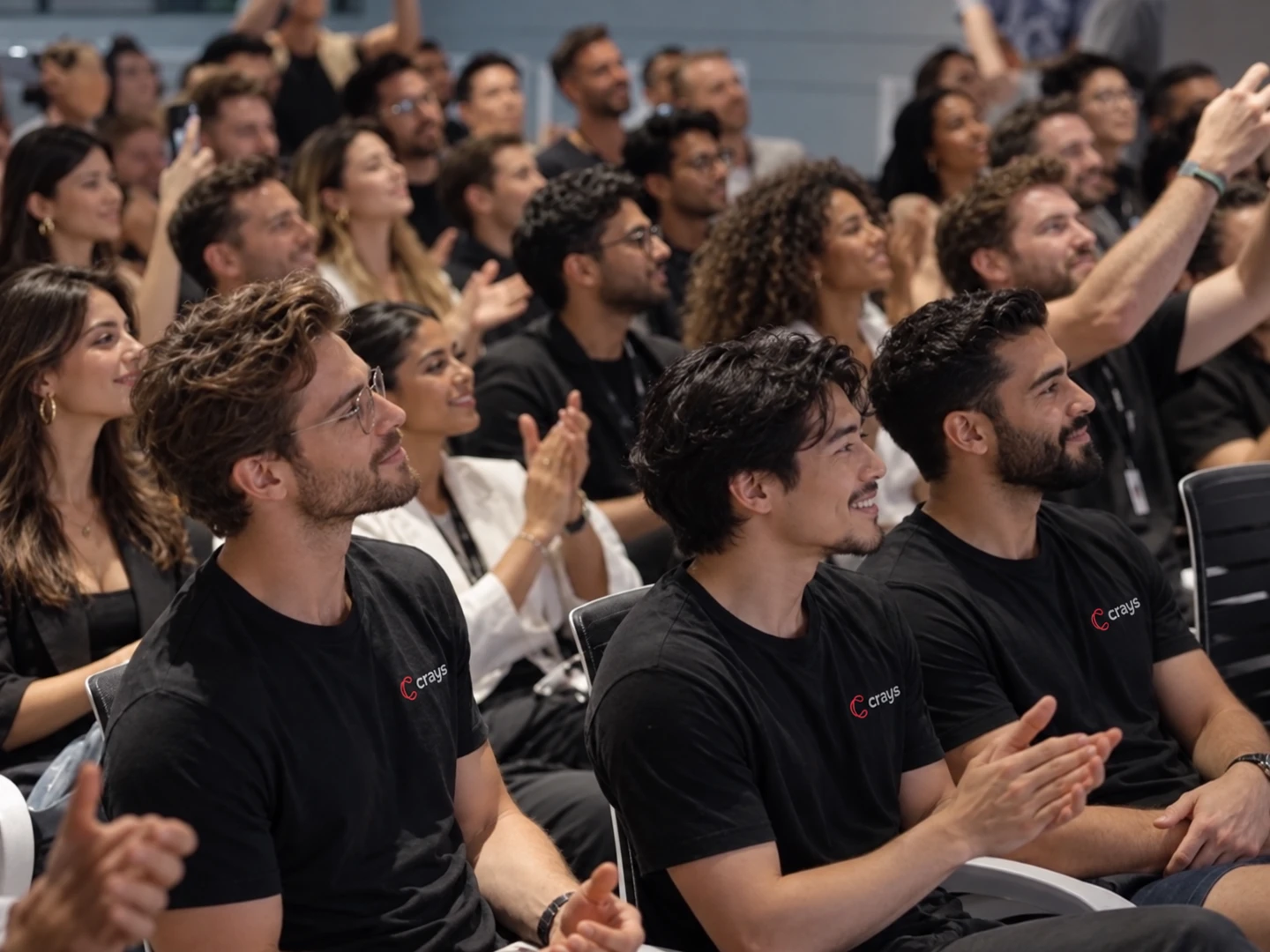A community audience applauding together