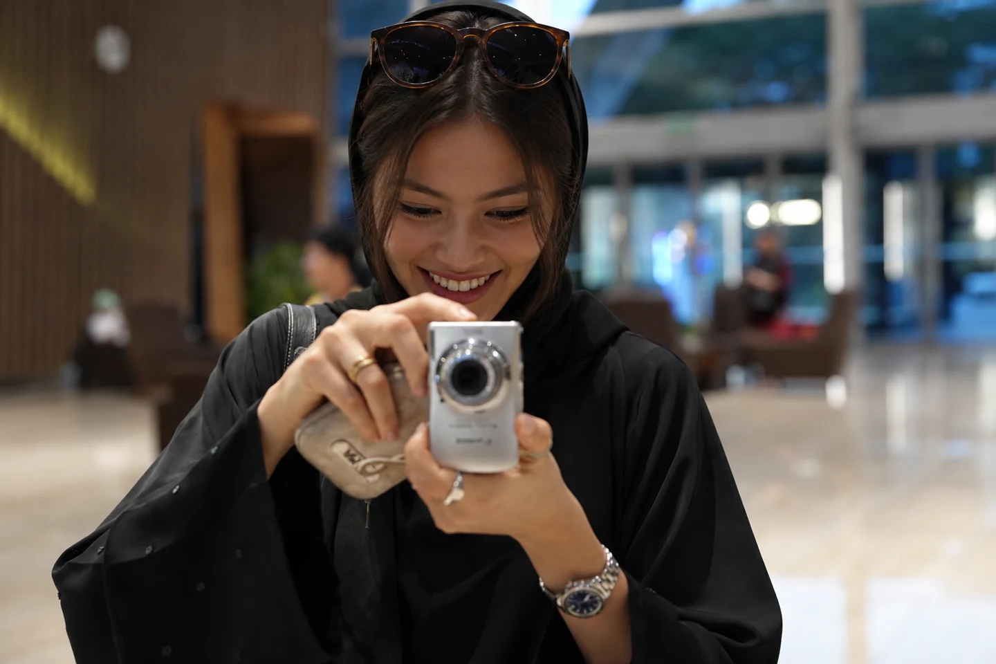 A creator enjoying taking photographs with her camera